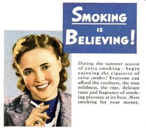 Old print advert - smoking is believing! Woman smiling whilst holding a cigarette 