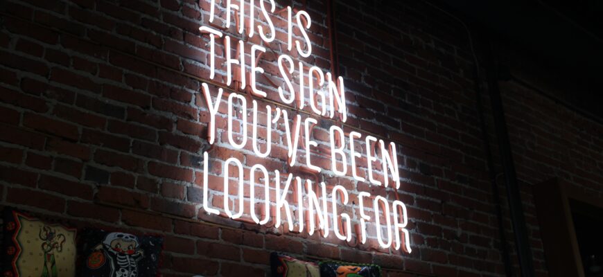 A photo of a neon sign with the words 'This is the sign you've been looking for'